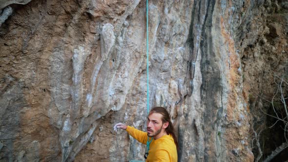 Slow Motion of Joyful Handsome Man Rock Climber Hanging on Rope and Give High Five After Successful