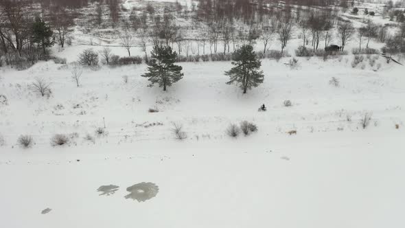 Two guys riding motorcycles in the snow