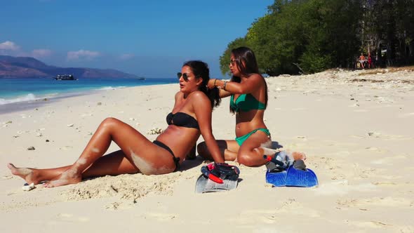 Female models happy together on beautiful coast beach time by clear ocean with white sandy backgroun