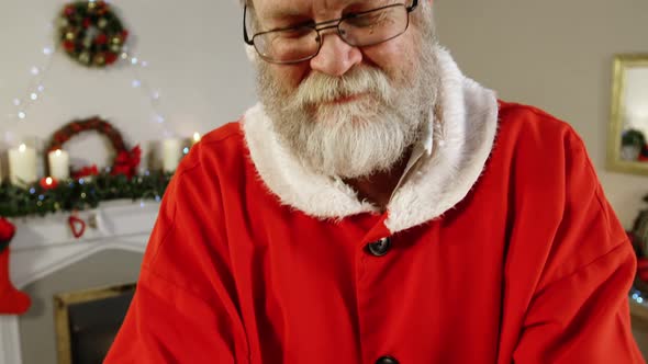 Santa claus holding a gift box