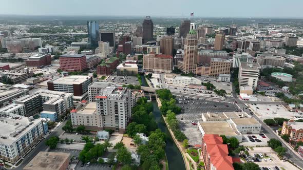 Downtown San Antonio skyline. Descending aerial with Riverwalk.