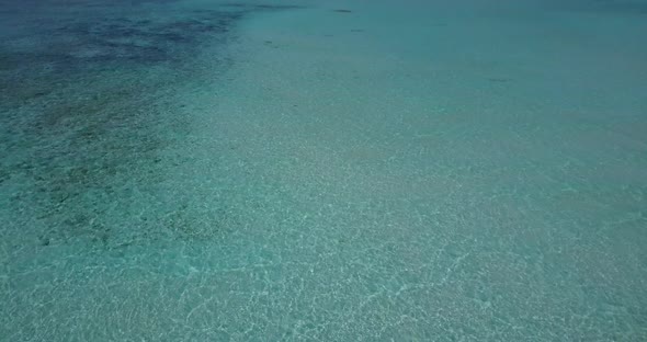 Luxury flying copy space shot of a summer white paradise sand beach and aqua blue water background 