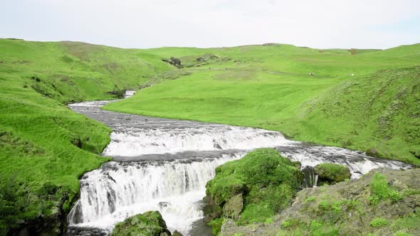 Skogafoss Waterfalls and Mountains in Summer Season Iceland Slow Motion