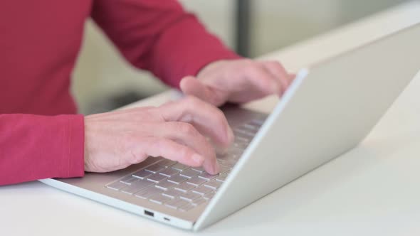 Hands of Old Man Typing on Laptop