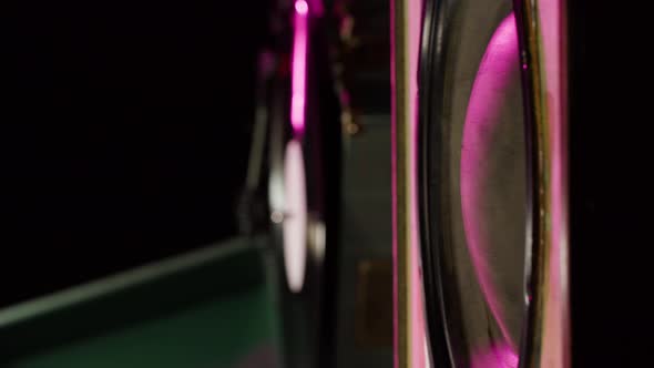 Vertical Video of Subwoofer in Neon Light Closeup