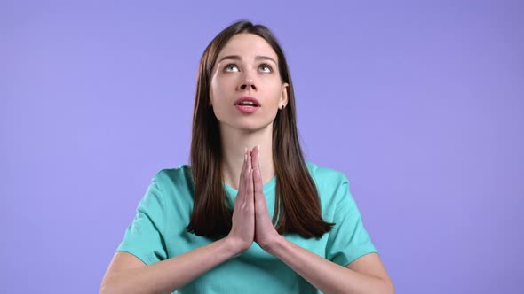 Beautiful Woman Praying Over Violet Background