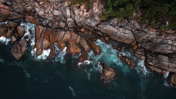 Aerial Top View  Footage By Drone of Ocean Blue Waves Break on High Cliff of a Rocky Mountain