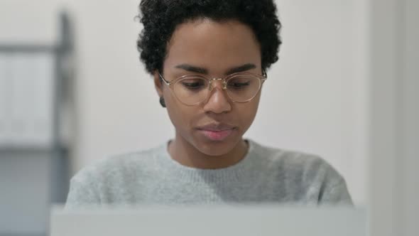 Portrait of African Woman with Laptop Looking at Camera 