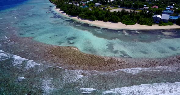 Natural fly over island view of a white sand paradise beach and blue sea background in high resoluti