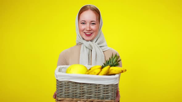 Positive Pretty Redhead Caucasian Woman Posing with Exotic Fruits at Yellow Background
