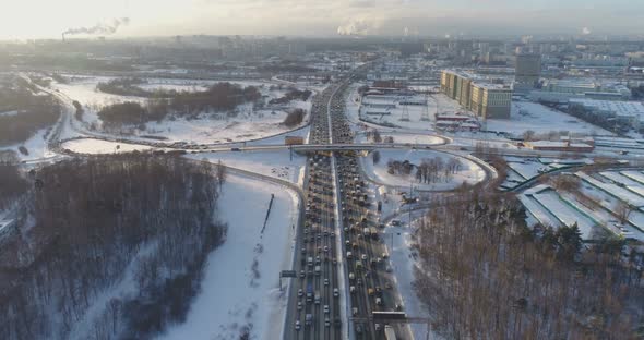 Cars on Highway at Sunny Winter Morning in the City. Aerial View