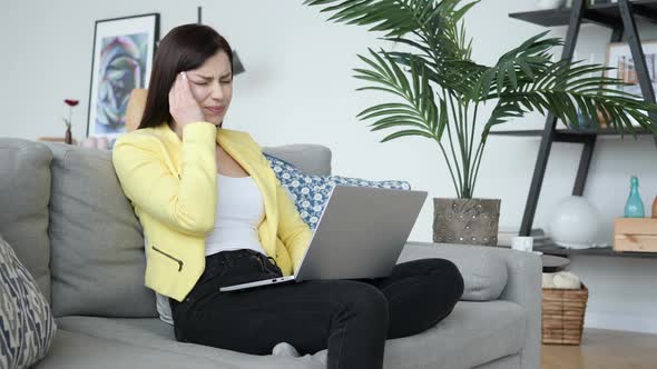 Headache Woman Working While Sittting on Sofa in Casual Place