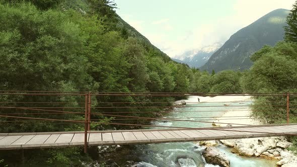 Aerial view of a wooden bridge with water going underneath at Soca River.