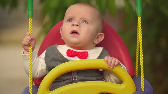 Little Kid Riding a Swing