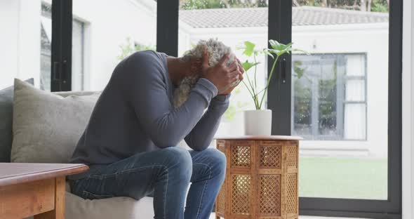 Video of sad african american senior man siting alone