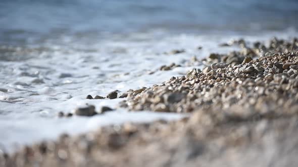 Ocean Waves Crushing in Rocky Beach Close Up