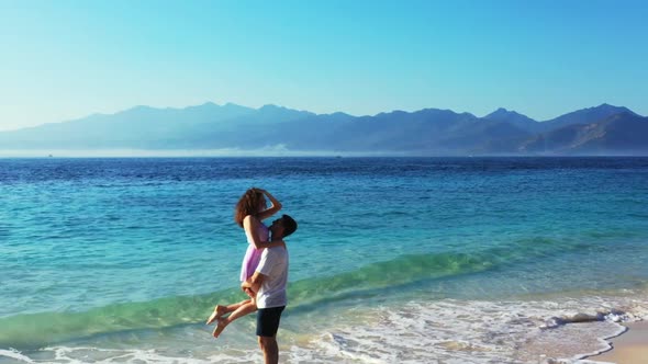 Man and lady suntan on marine resort beach break by blue water and white sand background of Gili Men