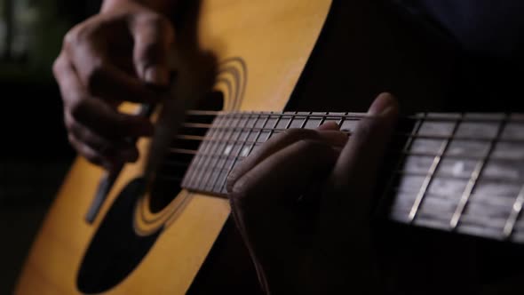 Close up vibrating string acoustic guitar