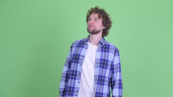 Happy Young Bearded Hipster Man Looking Around