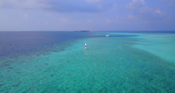 Daytime drone copy space shot of a paradise sunny white sand beach and blue water background 