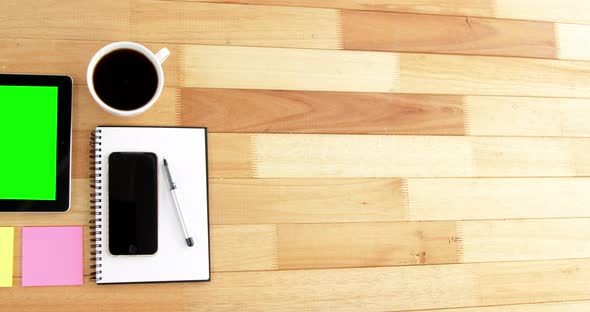 Digital tablet, coffee, spectacles, diary, mobile phone, pen and sticky notes