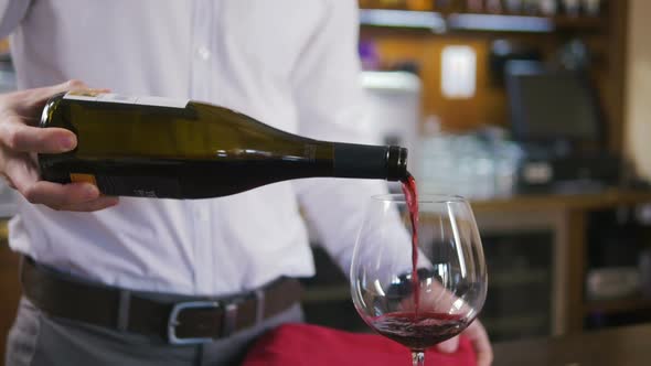 Sommelier Filling Glass with Wine in Restaurant Close Up Slow Motion