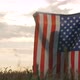 Patriotic Young Woman Stands in a Field and Holds the US Flag Behind Her Back - VideoHive Item for Sale