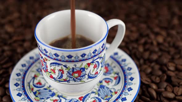 coffee. pouring Turkish coffee in cup with oriental ornaments