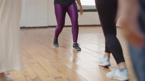 Closeup Shot of Dancers Legs Learning Dance Step in Studio