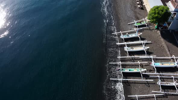 Top Down View on Boats on Black Sand Beach
