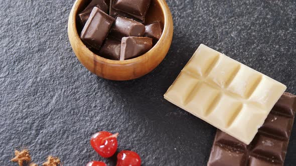 Chocolates and fruit on concrete background