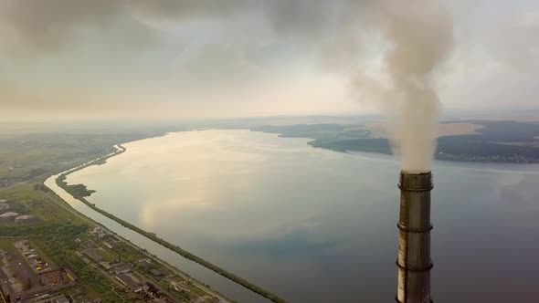 Aerial view of high chimney pipes with grey smoke from coal power plant. Production of electricity 