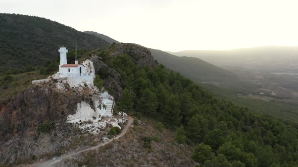 Tiny white church on mountainous hill in Pinos Del Valle, Lecrin Valley, Granada, Spain