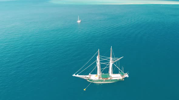 Sailing Ship Sails in a Wonderful Crystal Clear Sea Aerial View From Drone