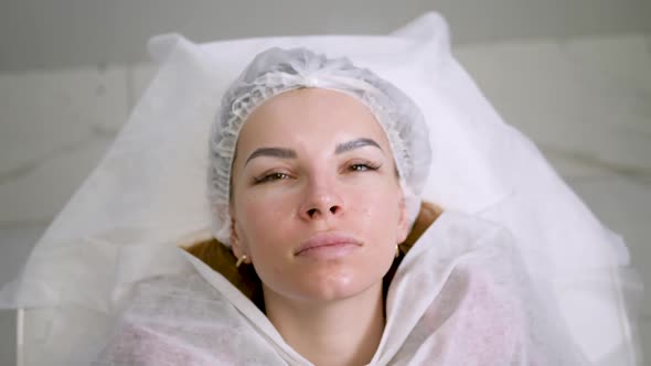 Face Beautiful Girl in a Medical Cap Lying Back on the Couch