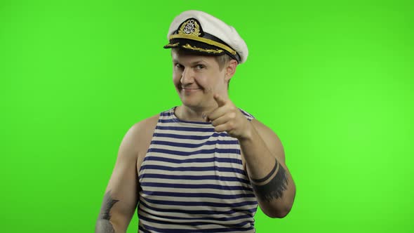 Young Sailor Man Shows Muscles, Looking at Camera. Seaman Guy in Sailor's Vest