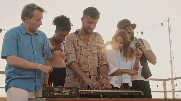 Young People Dancing at Party on Summer Evening