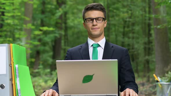 Healthy Employee Taking Deep Breath While Working on Laptop in Park, Fresh Air