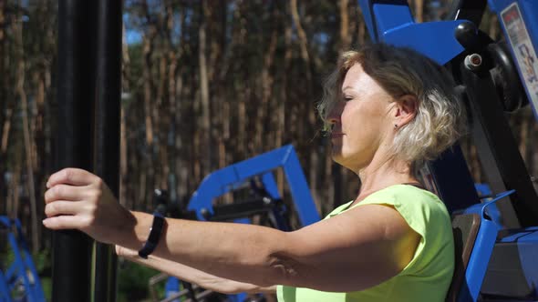 Middleaged Lady Does Strength Training for Upper Body