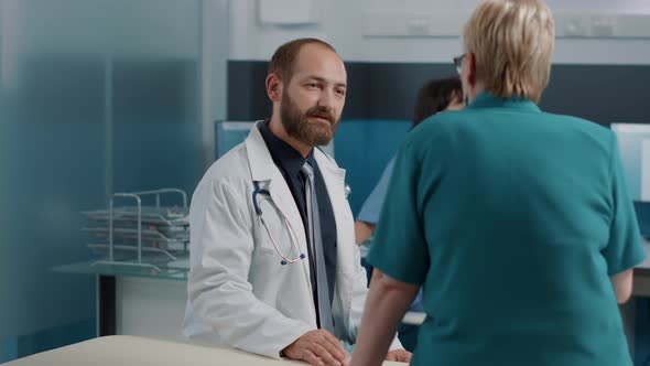 Medical Specialist Having Conversation with Elder Patient