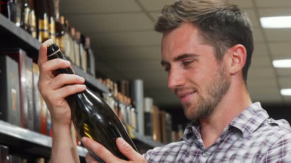 Handsome Man Smiling To the Camera Holding Wine Bottle 