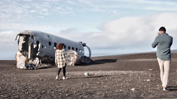 Scenic View of Bold Travelers Filming the Solheimasandur Plane Wreck at Sunset