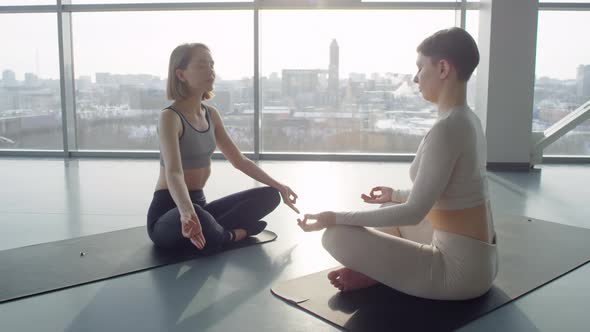 Young Women Meditating Together