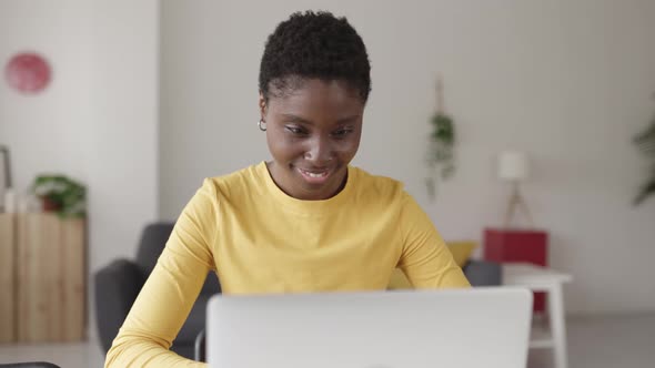 Young Happy African Woman Working on Laptop From Home alt