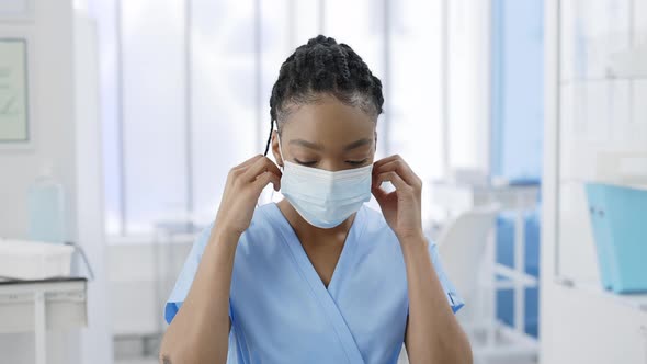 Portrait of Afro  American Female Nurse Taking Off Medical Protective Mask