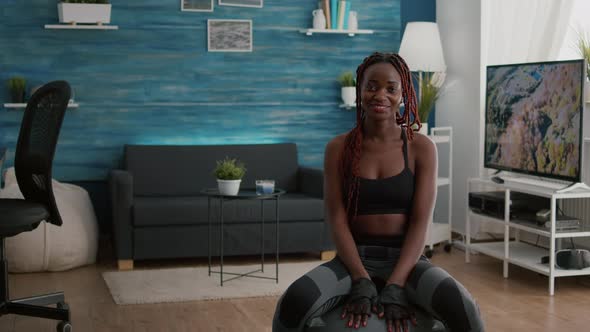 Portrait of Athetic Woman Looking Into Camera While Sitting on Yoga Ball