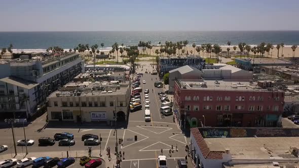 Bus at stop, cars waiting at traffic light to cross intersection.Daring aerial view flight panorama