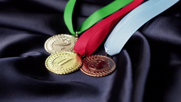 Gold Silver and Bronze Medals with Ribbons on Black Background Closeup