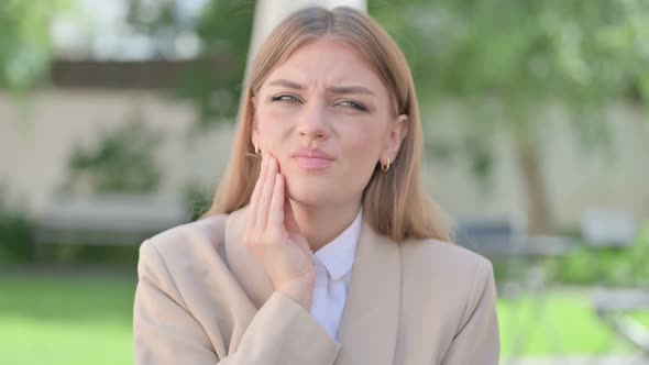 Outdoor Portrait of Young Businesswoman Having Toothache Cavity