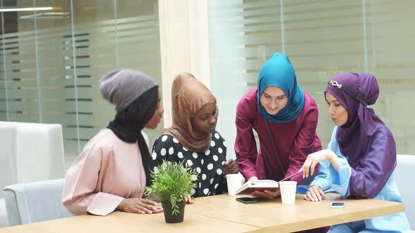 Group of Muslim Young Women Shopping On-line, Using Laptop Computer